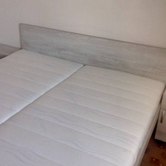 Maželská postel v klasických rozměrech 2000x1800 s nočníma stolkama na kolečkách a celovýsuvným šuplíkem. Dle přání zákazníka místo pod postelí na uložný prostor.